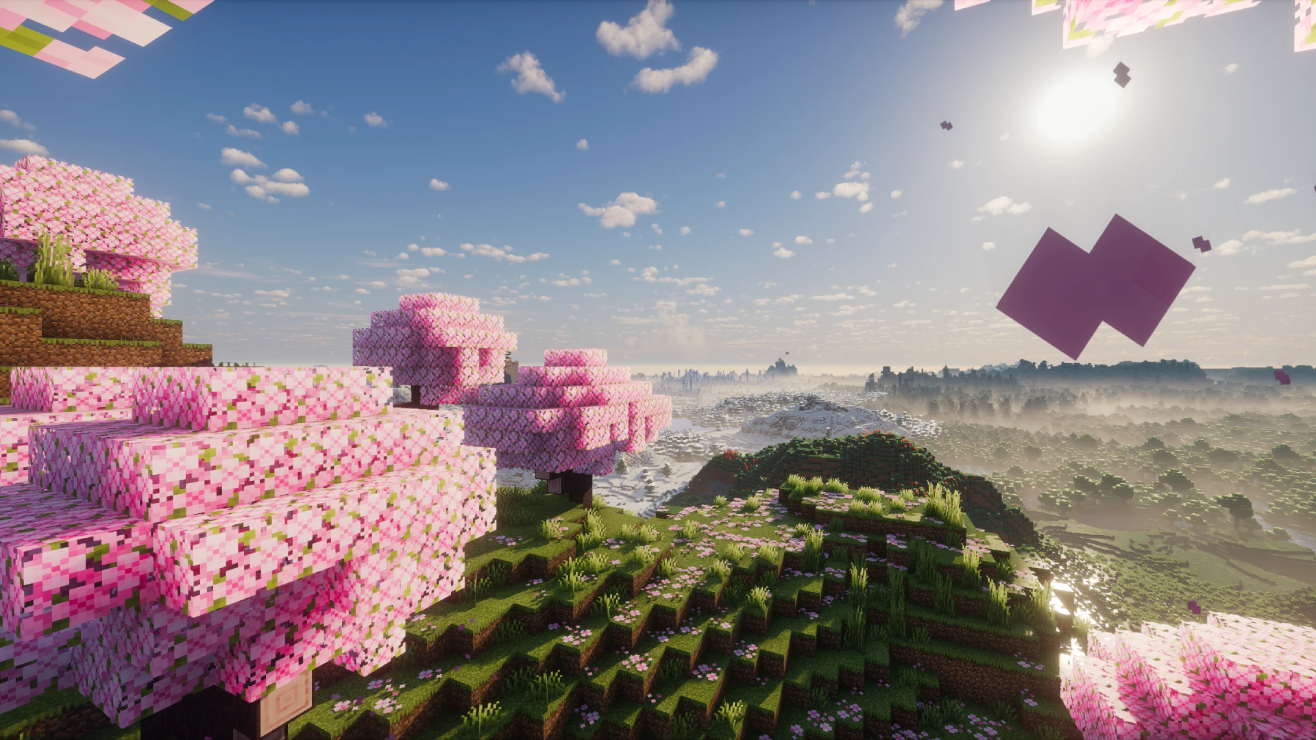 Pink cherry blossom trees on a grassy hillside above a misty Minecraft valley, rendered with shaders