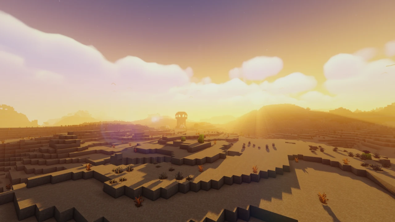 Low sun with a lens flare over sand dunes, with a lone tower on the horizon