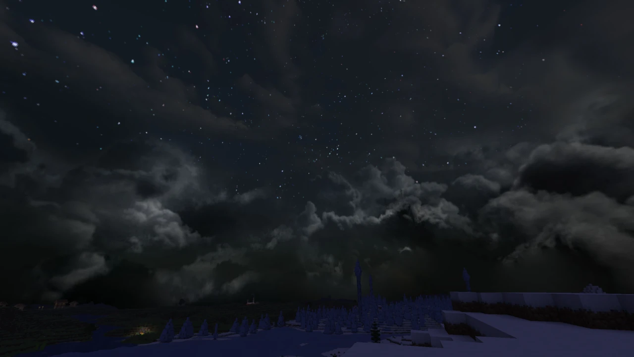 Starry night sky with dark drifting clouds over snowy ground